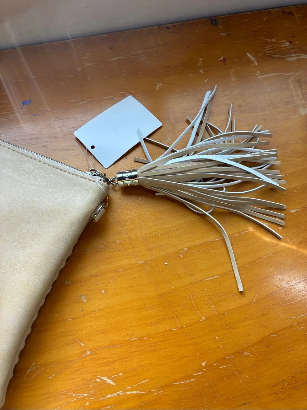 Woven Tassel Zip Clutch or strap is on the inside. Turns into a crossbody bag.